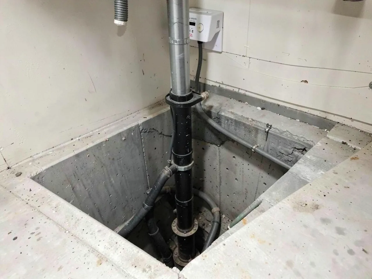 Sump pump installed in a basement sump pit