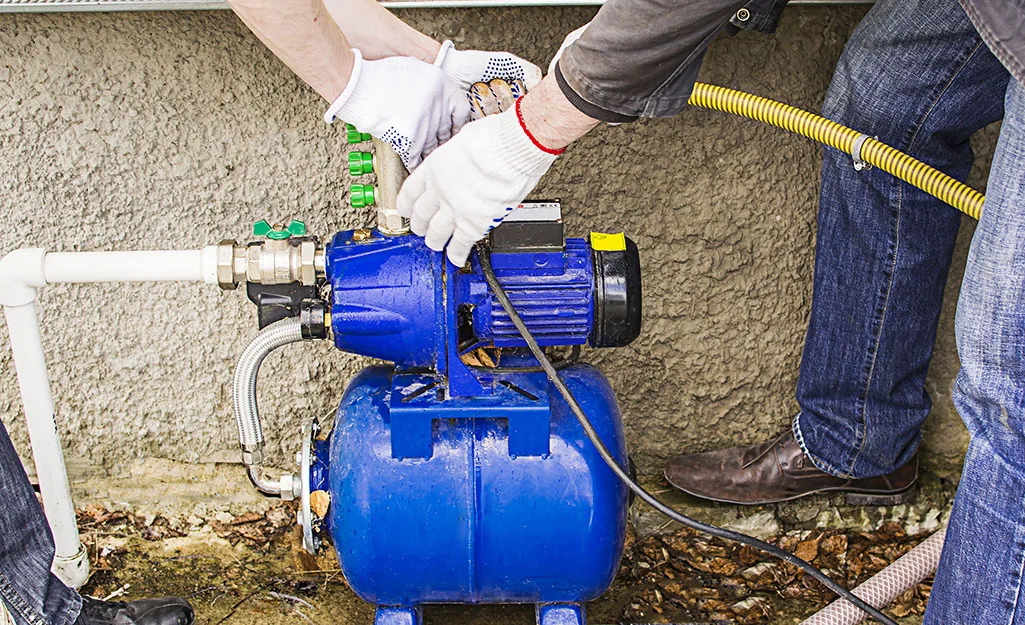 Technicians servicing a pump and pressure system